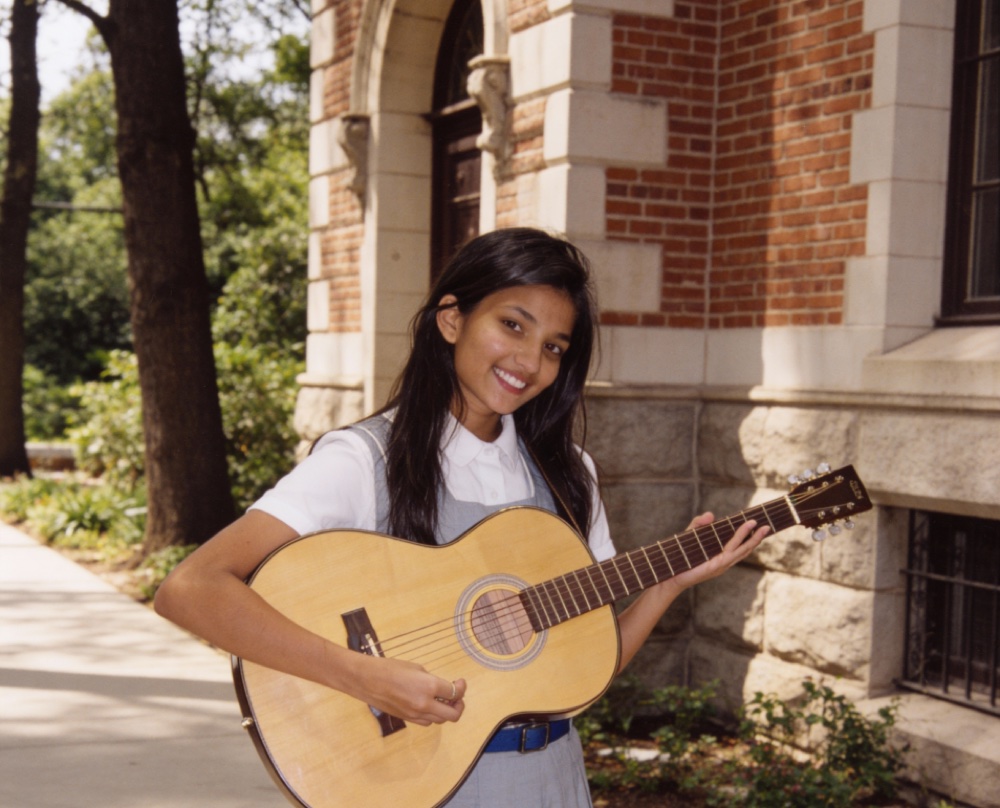 Zeel Jain as a teenager holding an acoustic guitar in Ahmedabad